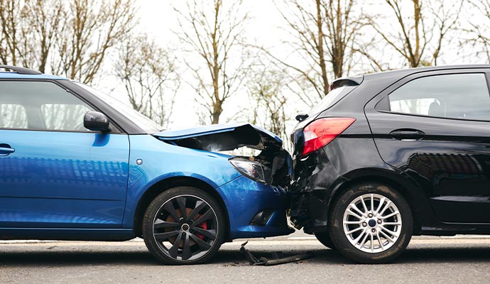 A rear-end collision between a blue car and a black car
