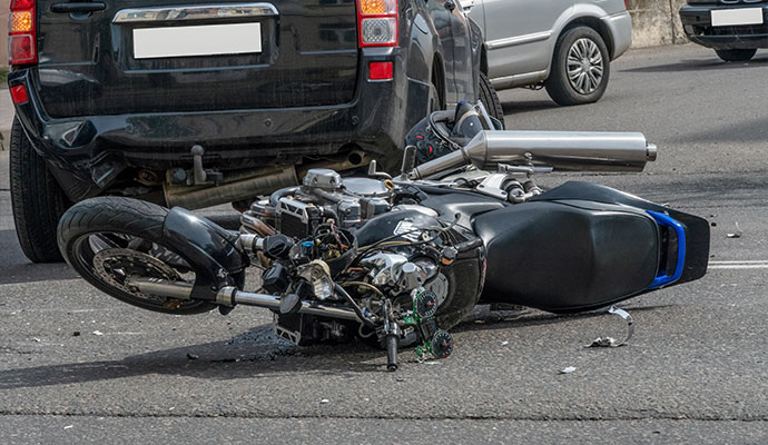 Black car rear end collision motorcycle