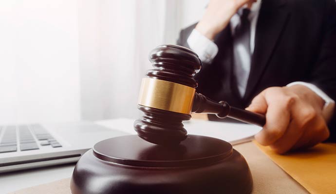 A close-up of a wooden judge's gavel on a sound block